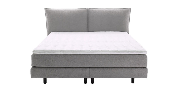 Boxspringbett Vita ohne Kissen und Dekoration in eine grauen Stoffbezug.