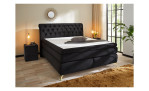 Boxspringbett Saragossa Mix in einem samtähnlichen Stoff in der Farbe schwarz, in einem Raum stehend