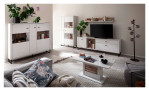 Basis-Wohnwand Louisa aus Holzwerkstoff in Modern White mit einer Rückwand in Viking Oak Leistenoptik. Auf einem dekorierten Hintergrund.