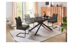 Esstisch Sölden mit schwarzer Tischplatte in Marmoroptik in einem Esszimmer mit Schwingstühlen darum.
