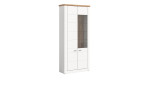 Vitrine Manhattan in weiß mit einer Deckplatte in Nox Oak aus Holzwerkstoff. Schräge Seitenansicht.