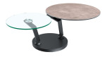 Couchtisch MONDO Varium mit einer Glas-Keramik Tischplatte in Zementgrau und einer Klarglasplatte mit einem schwarzen Stahlgetsell.