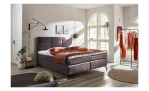 vito Asetto Basis - Boxspringbett in der Farbausführung Beluga, in einem Raum stehend