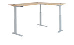 Elektro-Winkelschreibtisch mit holzfarbener Tischplatte und silbernem Gestell ganz hoch eingestellt.