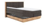 Boxspringbett VALMONDO Incana in einem Stoffbezug in Charcoal und einem Sichtholzrahmen in Eiche. Mit geöffneten Bettkasten