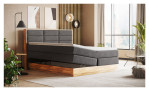 Boxspringbett VALMONDO Incana in einem Stoffbezug in Dark Grey und einem Sichtholzrahmen in Eiche. Mit geöffneten Bettkasten