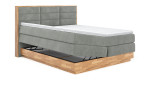Boxspringbett VALMONDO Incana in einem Stoffbezug in Desert und einem Sichtholzrahmen in Eiche. Mit geöffneten Bettkasten