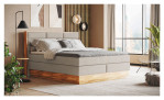Boxspringbett VALMONDO Incana in einem Stoffbezug in Natural und einem Sichtholzrahmen in Eiche Auf einem dekorierten Hintergrund