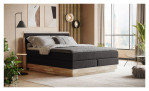 Boxspringbett VALMONDO Incana in einem Stoffbezug in Charcoal und einem Sichtholzrahmen in Eiche. Auf einem dekorierten Hintergrund