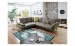 Komfort-Ecksofa vito Ticona, in der Farbausführung Anthrazit / Olive, in einem Raum stehend