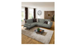 Komfort-Ecksofa vito Bevy, in der Farbausführung Stone, in einem Raum stehend