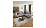 Basis-Ecksofa vito Bevy, in der Farbausführung Grau, in einem Raum stehend